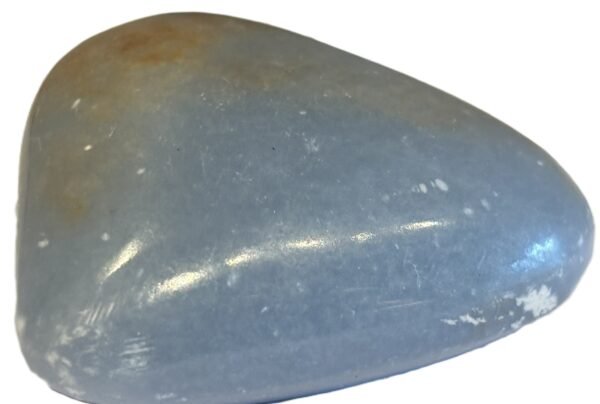 Polished natural angelite carved heart crystal 1 sians emporium Smooth polished blue angelite carved heart crystal showing natural white mineral flecks on a white background
